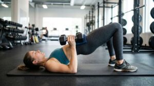 Glute bridge with dumbbell resting on hips