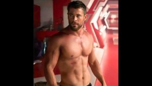 Chris Hemsworth as Thor shirtless, showing ripped abs and broad shoulders