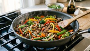 ground beef and vegetable stir fry in a skillet