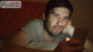 man using phone late night addiction